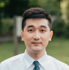 Outside headshot of man wearing a white shirt and tie